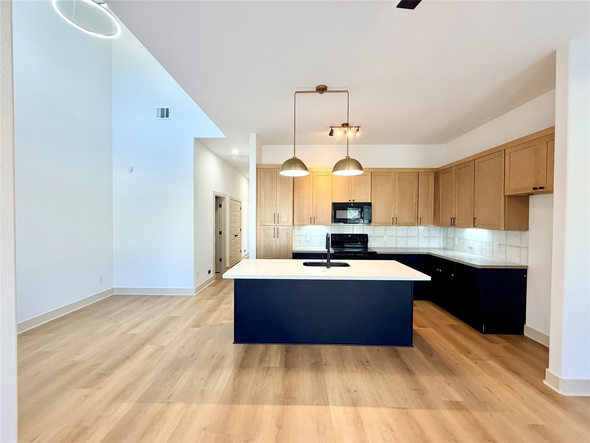 4214 Clover Street Houston, TX 77051 - Photo 10 of 34 a kitchen with kitchen island granite countertop a sink cabinets and stainless steel appliances