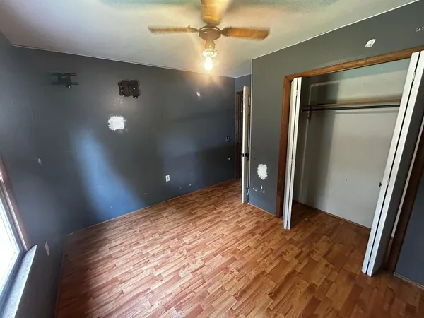 a view of a livingroom with a flesh screen tv and window