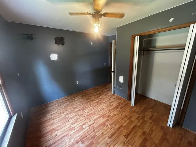 a view of a livingroom with a flesh screen tv and window