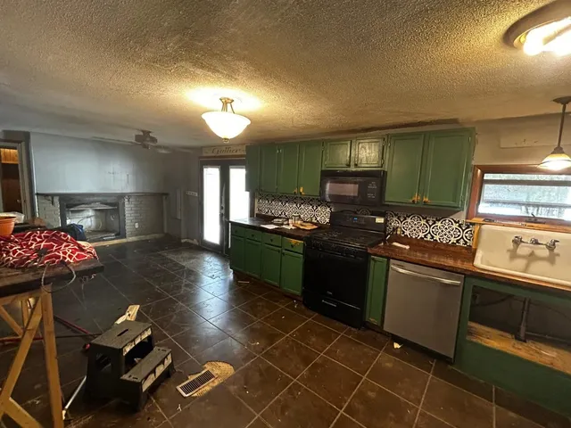 a kitchen with granite countertop a stove and a sink