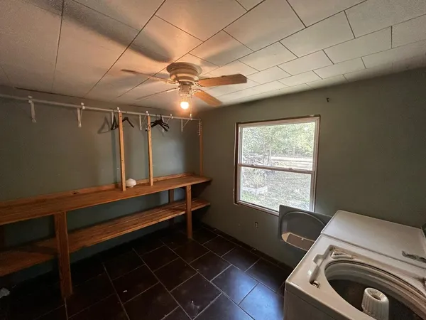 a room with gym equipment and wooden floor