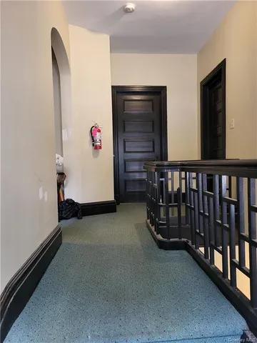 a view of a porch with wooden floor and stairs
