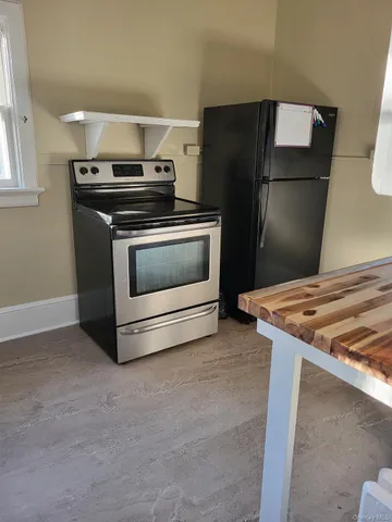 a kitchen with a stove and a refrigerator