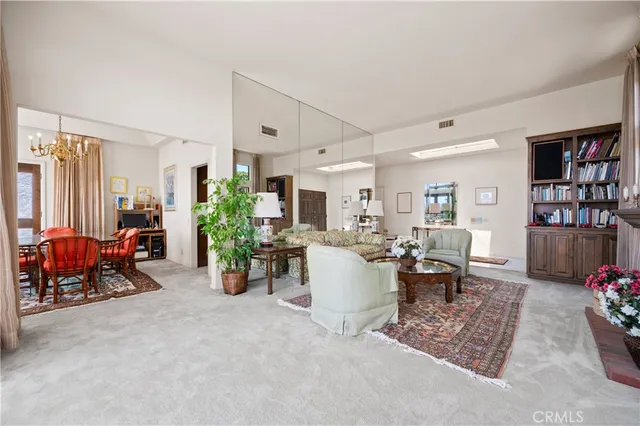 a dining room with furniture and a floor to ceiling window