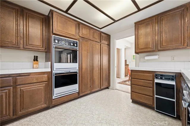 a bedroom with bed and paintings on the wall