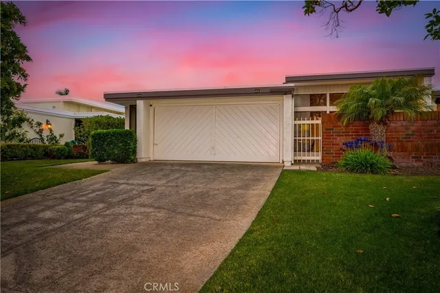 an aerial view of residential houses with outdoor space and ocean view