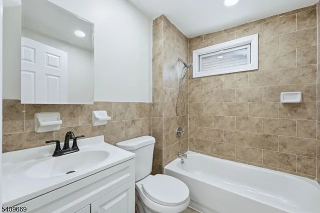 a bathroom with a sink a toilet and bathtub