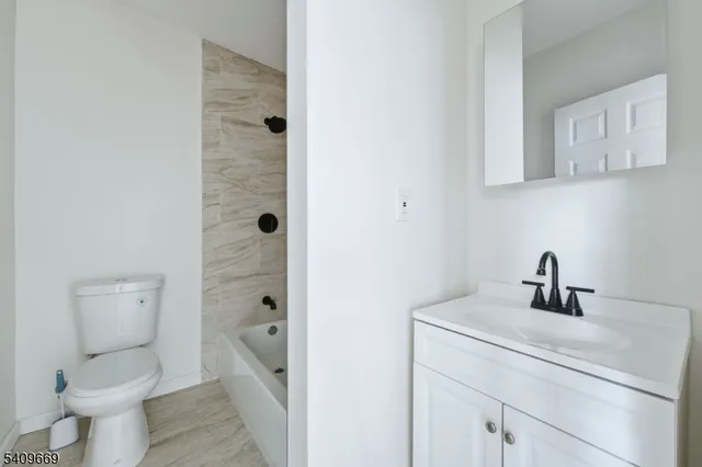 a bathroom with a toilet sink and shower