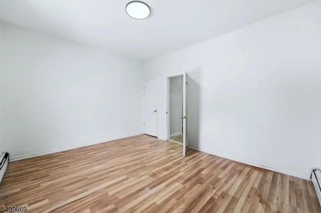 a view of room with wooden floor