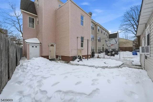 a view of a house with snow on the road