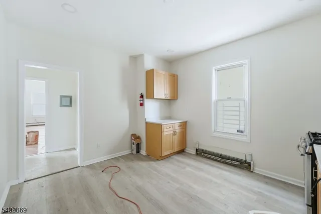 a view of room with window and a ceiling fan