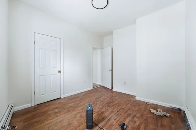 a view of room with wooden floor