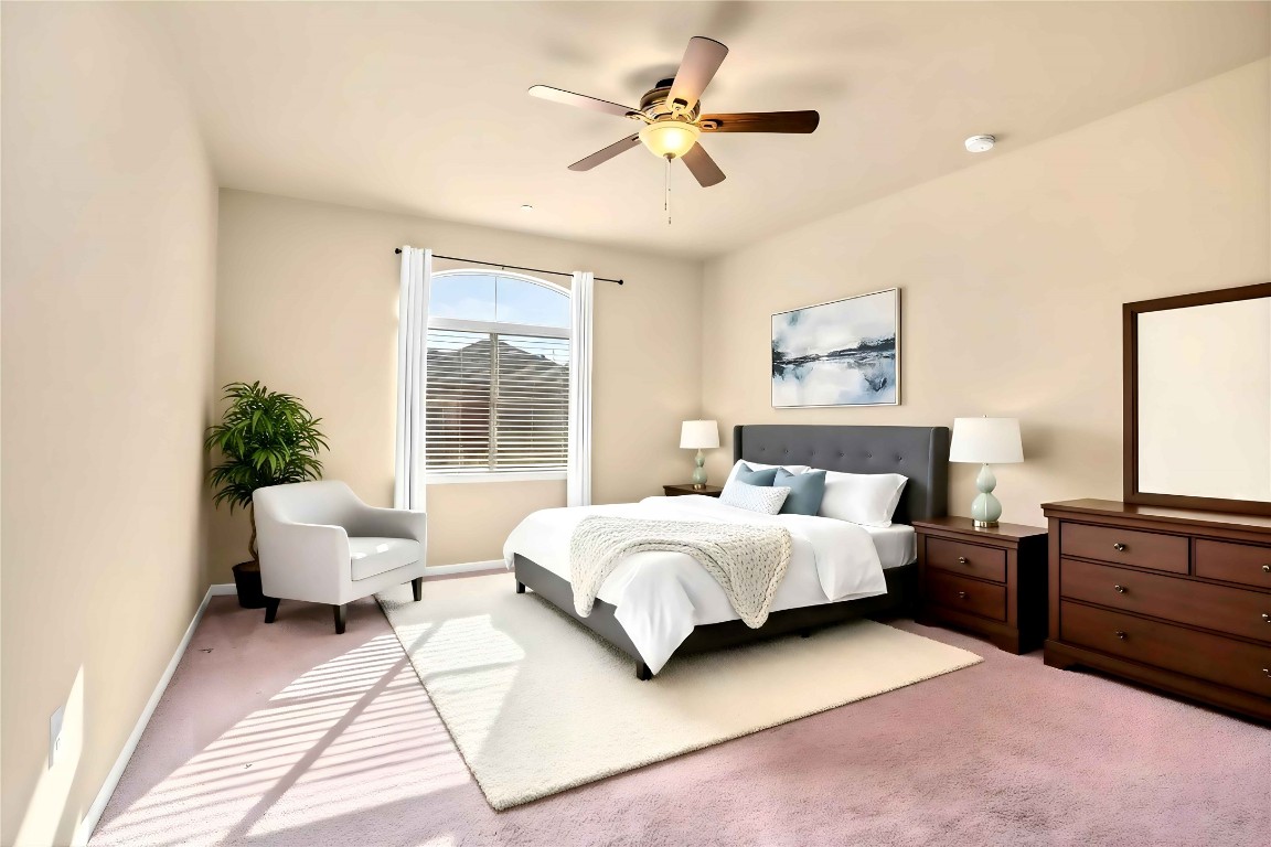 2880 Donnell Drive, Unit 2003 Round Rock, TX 78664 - Photo 20 of 27 a spacious bedroom with a bed a couch and a chandelier