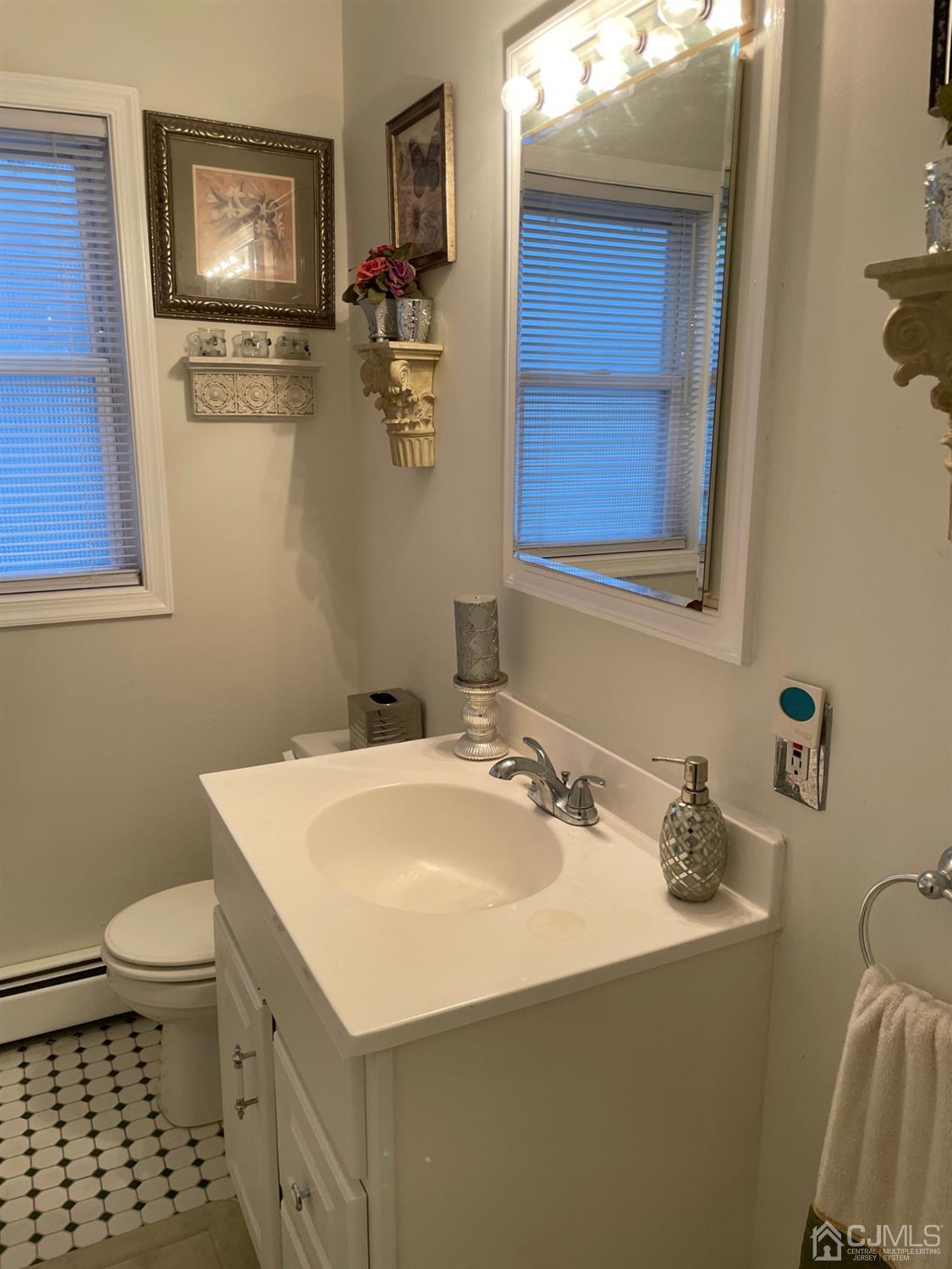 94 South Hill Road Colonia, NJ 07067 - Photo 11 of 15 a bathroom with a sink a toilet and mirror