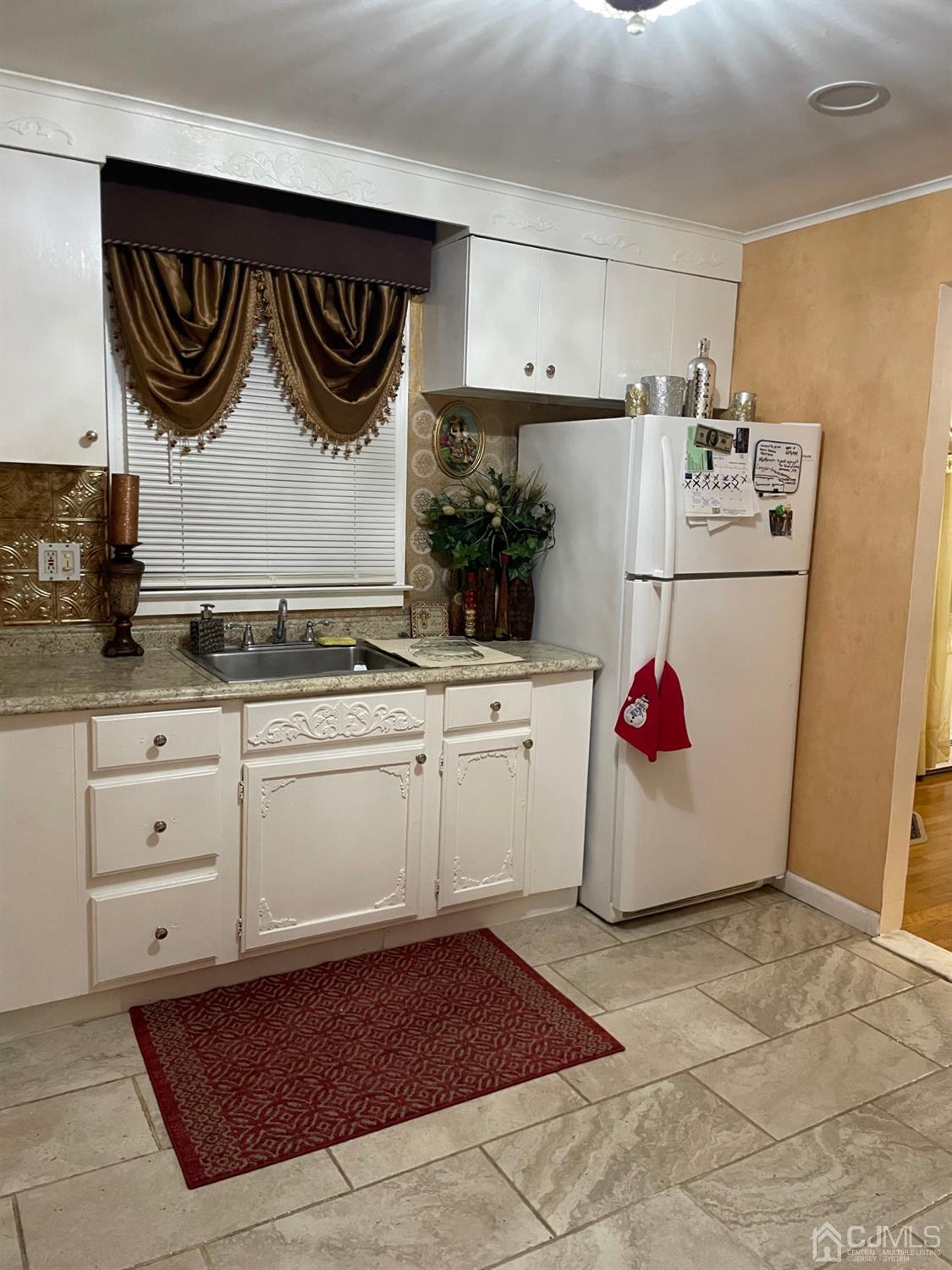 94 South Hill Road Colonia, NJ 07067 - Photo 3 of 15 a kitchen with white cabinets and white appliances