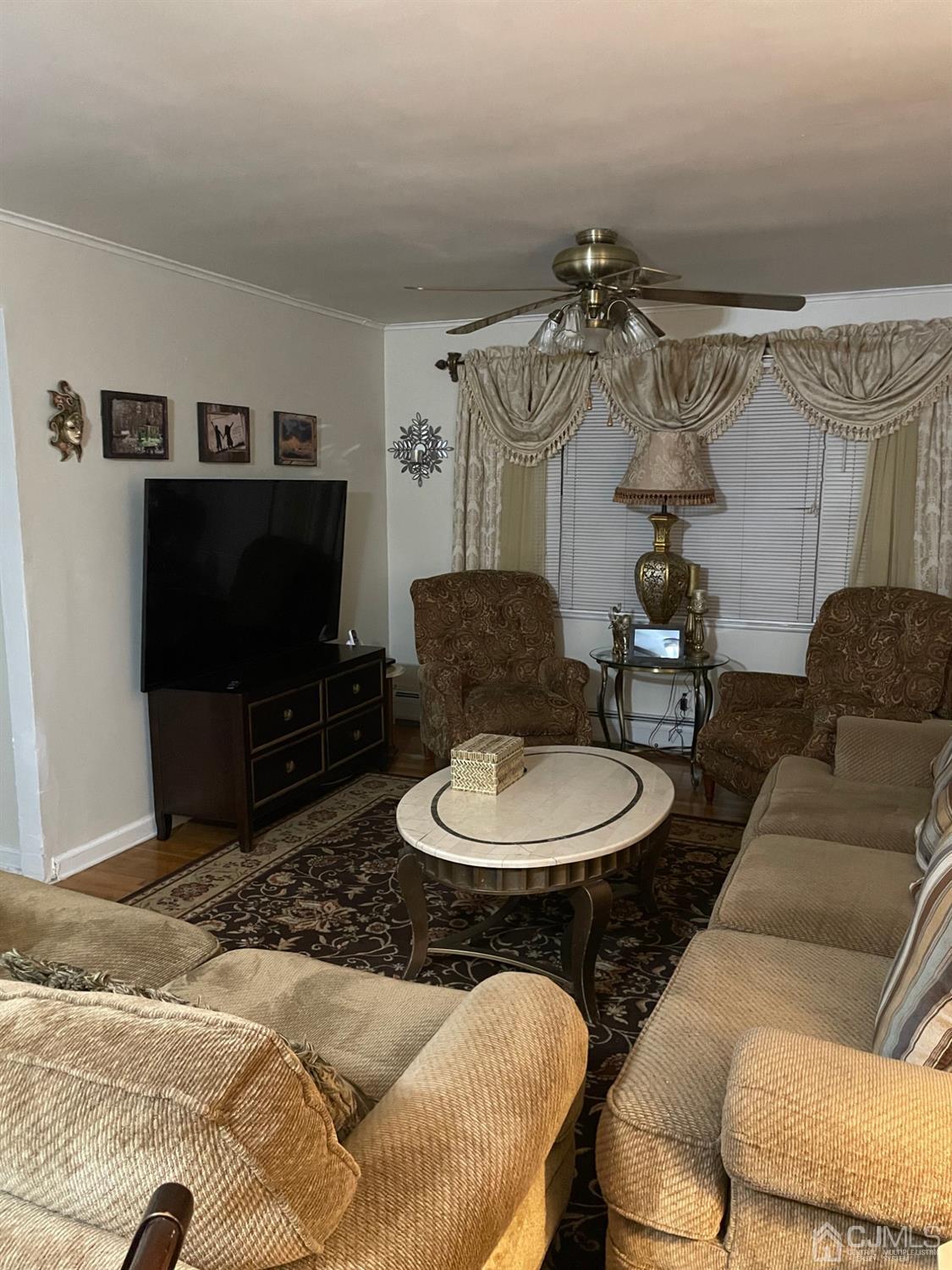 94 South Hill Road Colonia, NJ 07067 - Photo 6 of 15 a living room with furniture and a flat screen tv