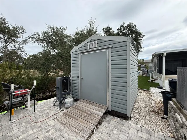 a roof deck with table and chairs and potted plants