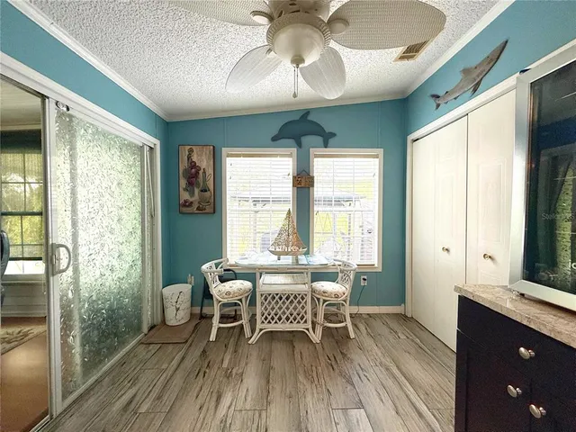 a dining room with furniture window and wooden floor