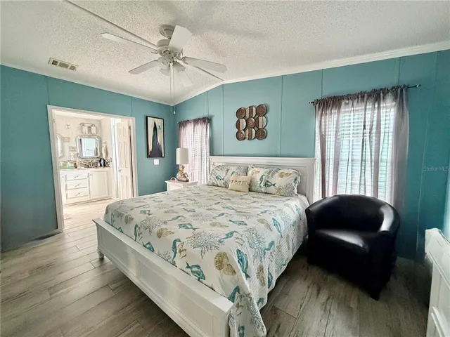 a bedroom with a bed mirror and window