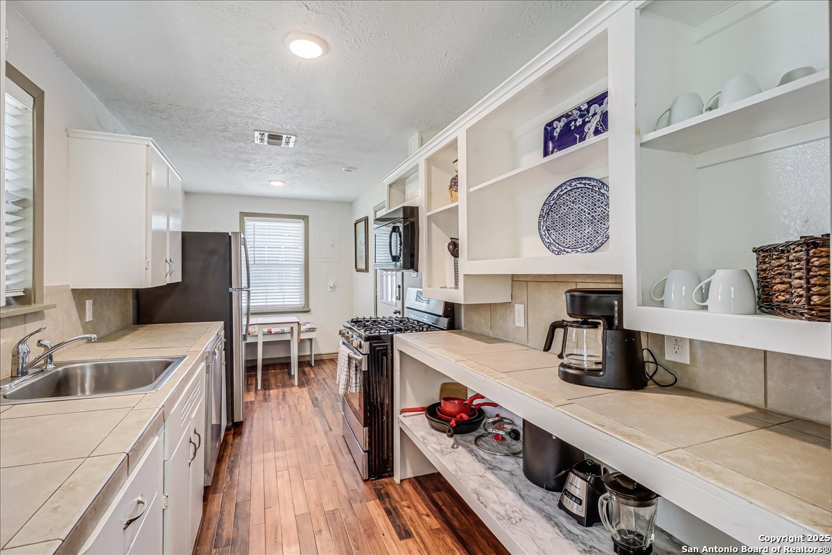 6031 Loop 1781 Rockport, TX 78382 - Photo 27 of 42 a kitchen with a sink a stove and cabinets