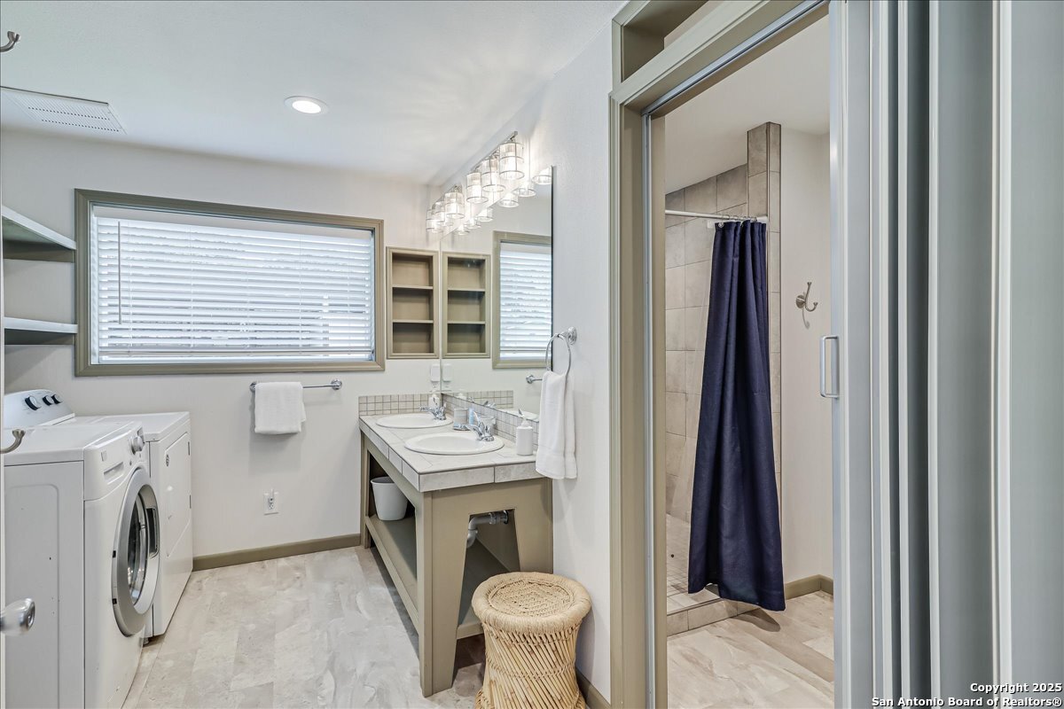 6031 Loop 1781 Rockport, TX 78382 - Photo 34 of 42 a bathroom with a sink a washer and dryer