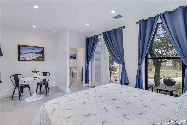 a spacious bathroom with a double vanity sink and a mirror