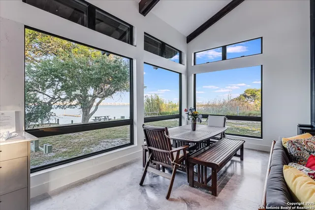 a dining room with furniture and a floor to ceiling window
