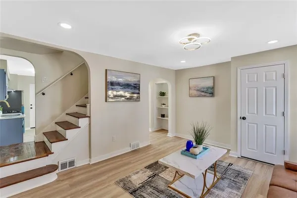 a living room with furniture and wooden floor