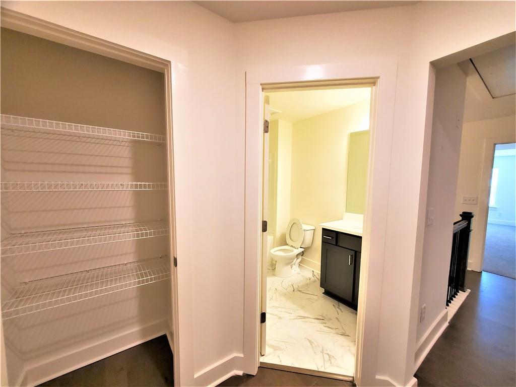 389 Auburn Valley Way Auburn, GA 30011 - Photo 13 of 29 a view of bathroom and hallway with wooden floor