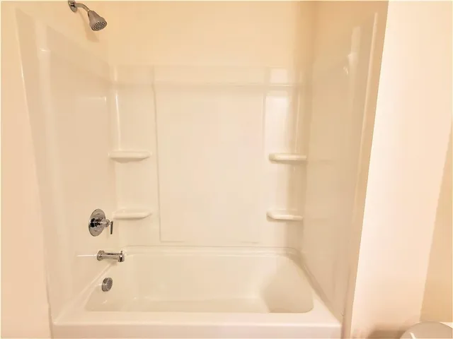 a white bath tub sitting next to a white sink