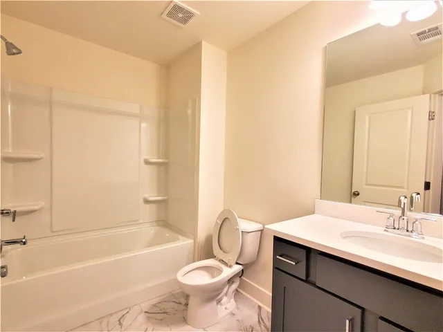 a bathroom with a sink a toilet and bathtub