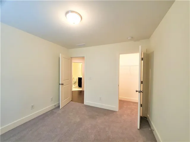 an empty room with a en suite bathroom