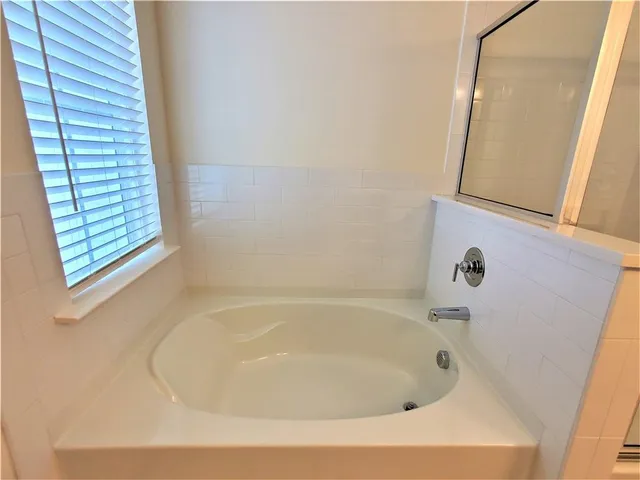 a white bath tub sitting next to a window