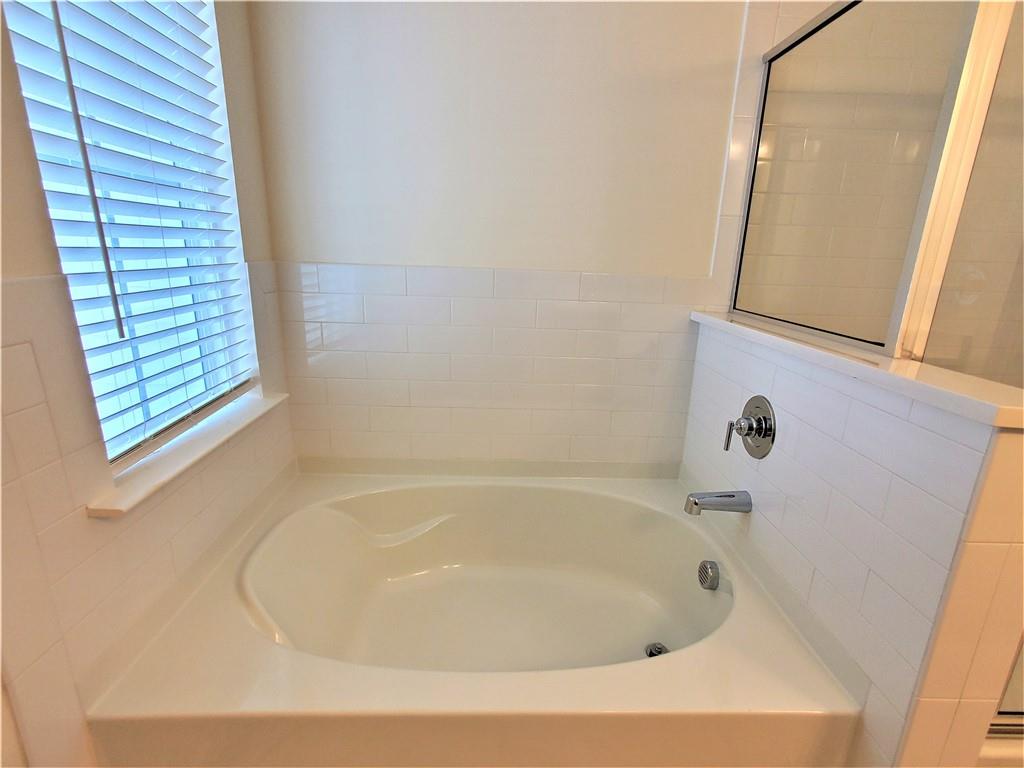 389 Auburn Valley Way Auburn, GA 30011 - Photo 24 of 29 a white bath tub sitting next to a window