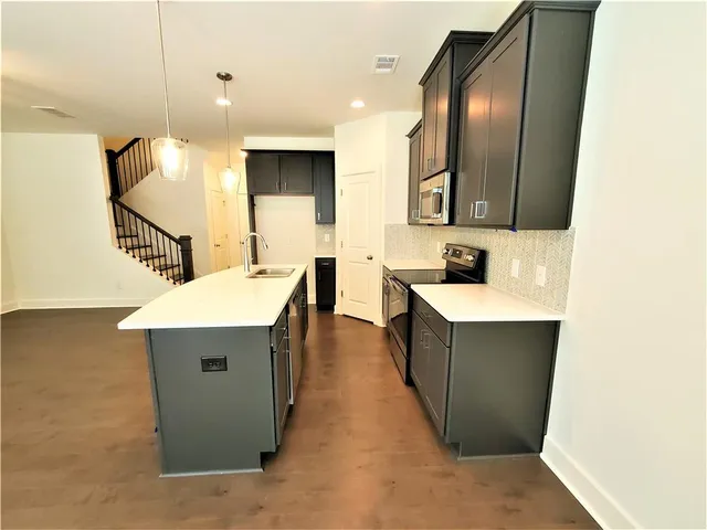 a kitchen with a sink and a refrigerator