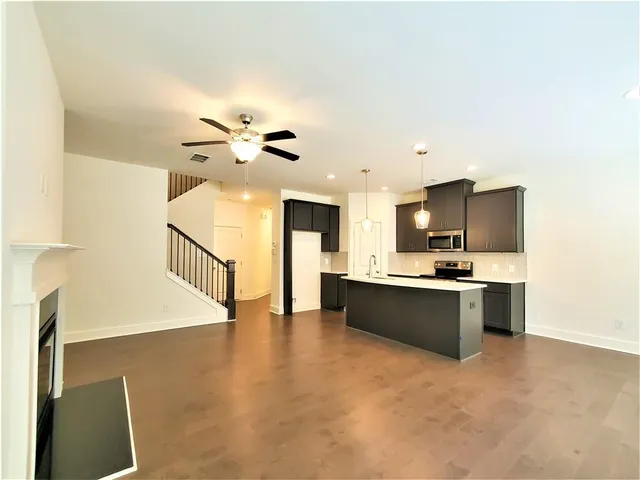 a view of a kitchen with a sink a kitchen area a sink and a refrigerator