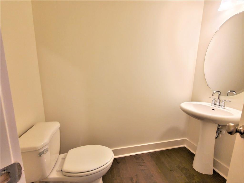 389 Auburn Valley Way Auburn, GA 30011 - Photo 9 of 29 a bathroom with a sink a toilet and a mirror