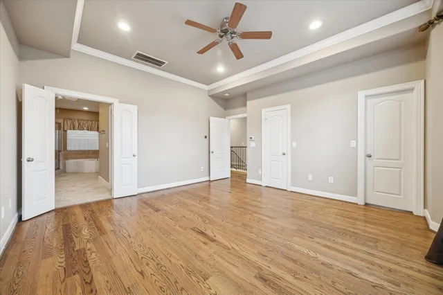 a view of an empty room and wooden floor