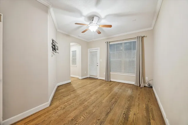 a view of empty room with wooden floor
