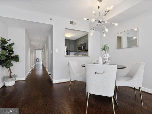 1150 K Street Northwest, Unit 709 Washington, DC 20005 - Photo 5 of 25 a view of a dining room with furniture and wooden floor