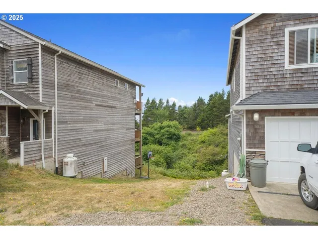 a backyard of a house with a table and chair