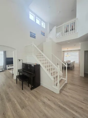 a view of entryway livingroom and hall with wooden floor
