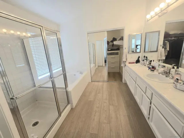 a bathroom with a double vanity sink and a mirror