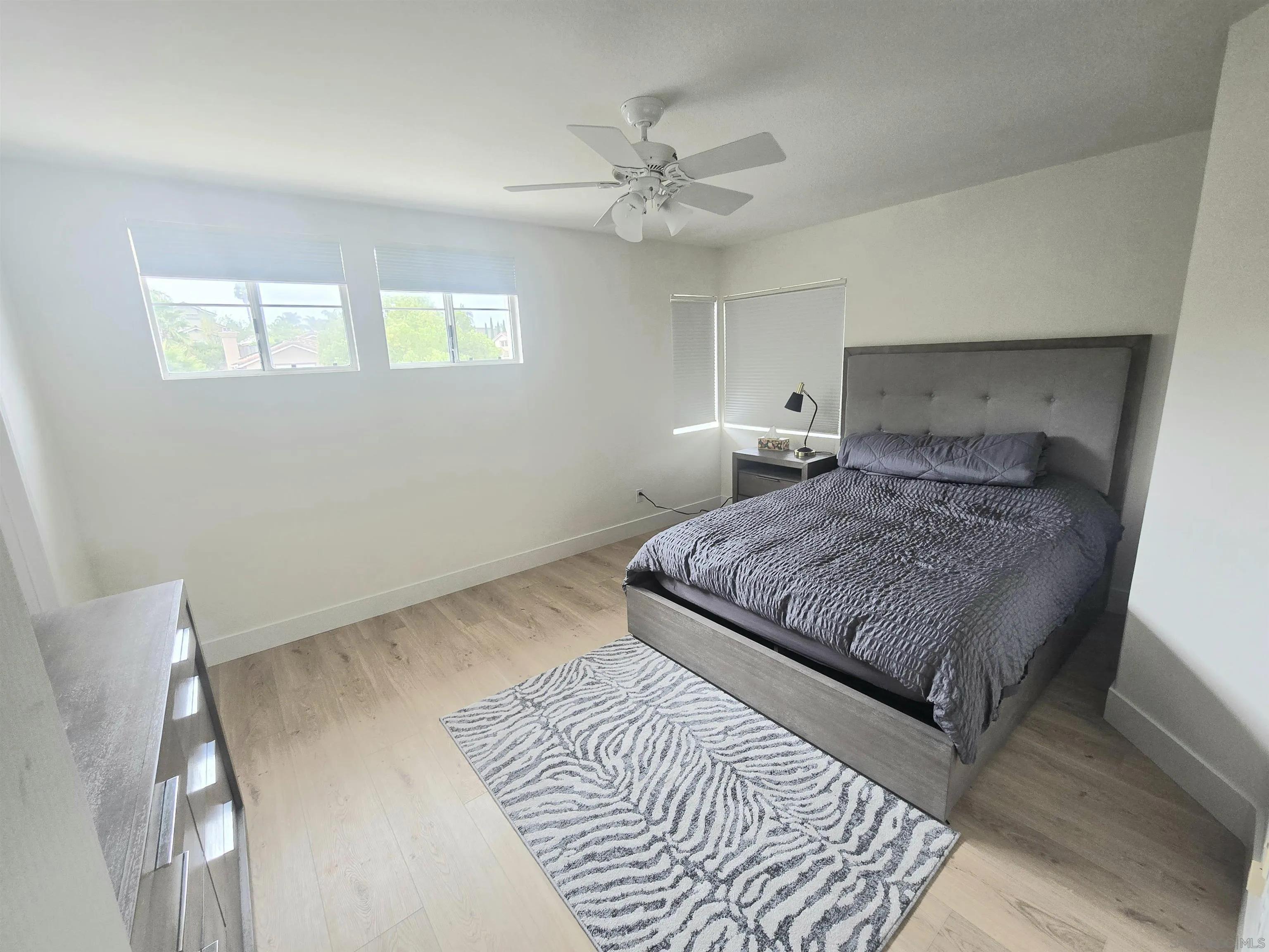 4802 Baroque Terrace Oceanside, CA 92057 - Photo 15 of 26 a bedroom with a large bed and a window