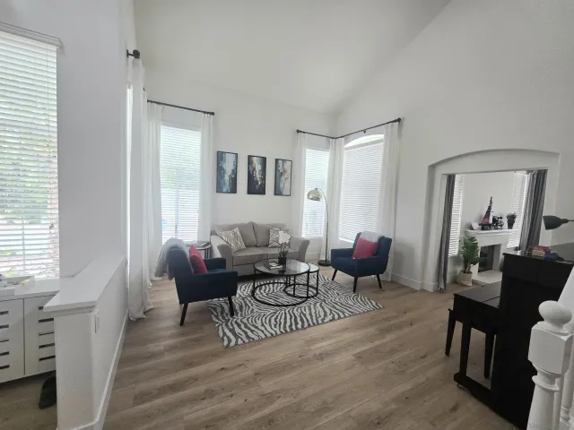 a living room with furniture and wooden floor