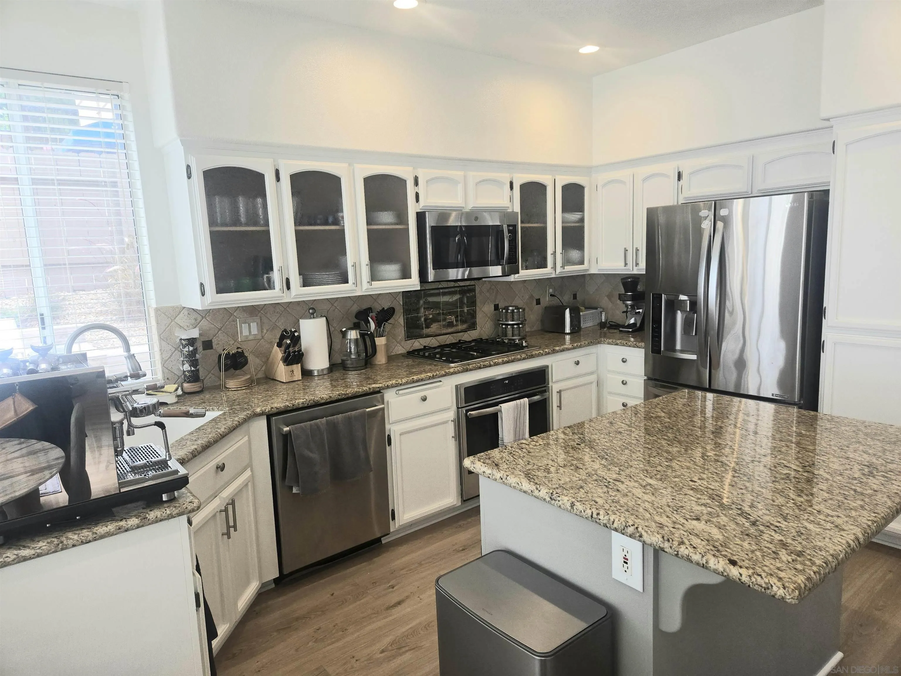 4802 Baroque Terrace Oceanside, CA 92057 - Photo 7 of 26 a kitchen with stainless steel appliances granite countertop a sink stove and refrigerator