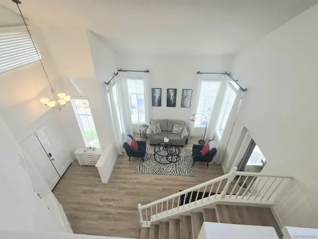 a view of living room with furniture and wooden floor