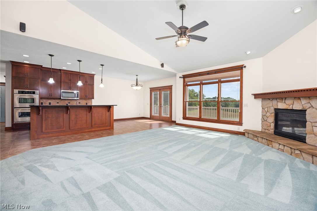 6925 River Styx Road Medina, OH 44256 - Photo 6 of 49 Expansive living area featuring a vaulted ceiling and light blue patterned carpet