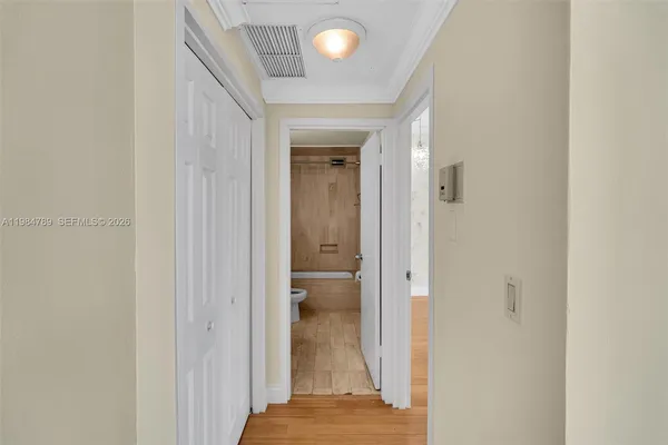 a view of a hallway with wooden shelves
