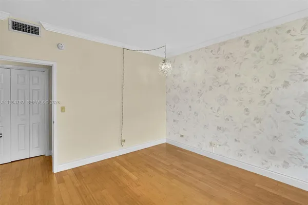 a view of a hallway with windows and entryway